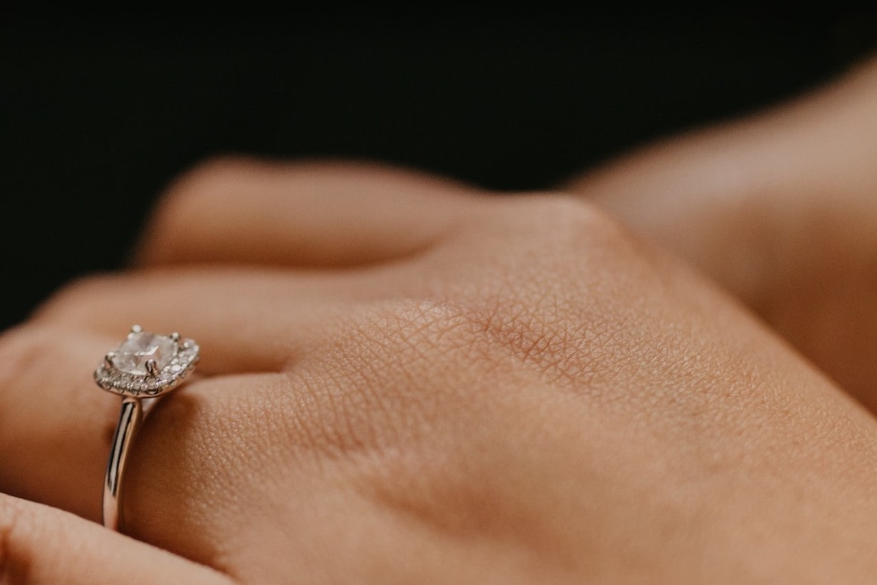 Close up image of a halo set, princess cut engagement ring