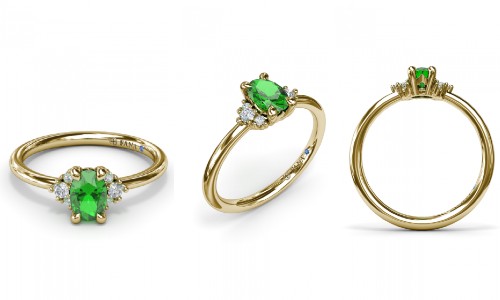 An emerald and yellow gold ring with diamond details