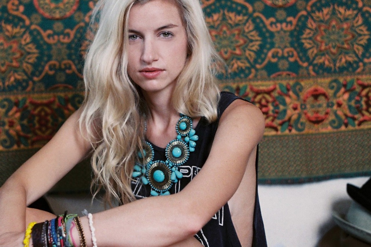 A woman with wearing an intricate turquoise necklace