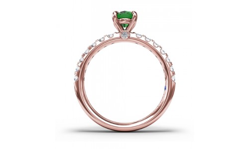 Emerald ring by Fana with a prominent center stone and prong set diamonds on the side
