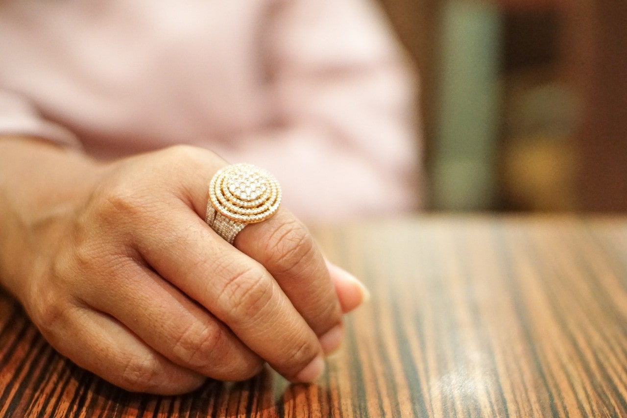 Person wearing a fashion ring with an eye-catching design